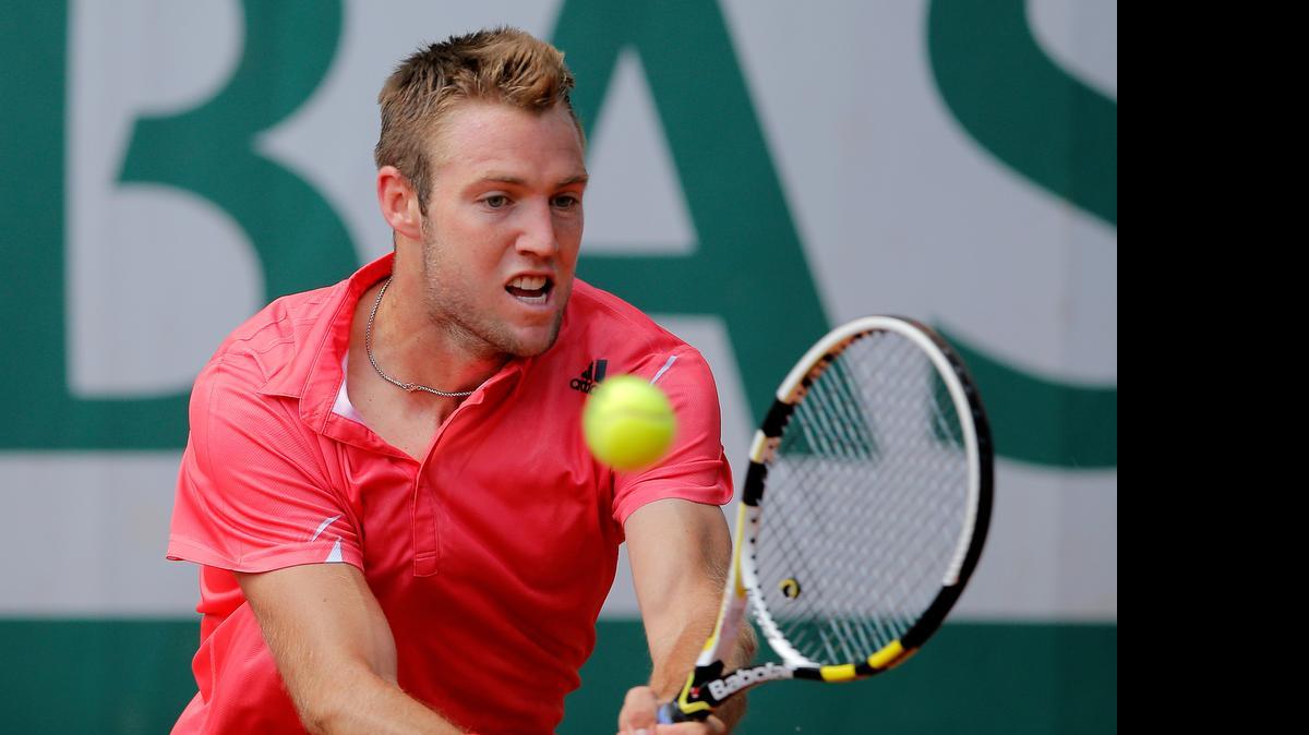 Jack Sock hits a return in a third-round match of the French Open against Borna Coric on Saturday at the Roland Garros stadium in Paris.