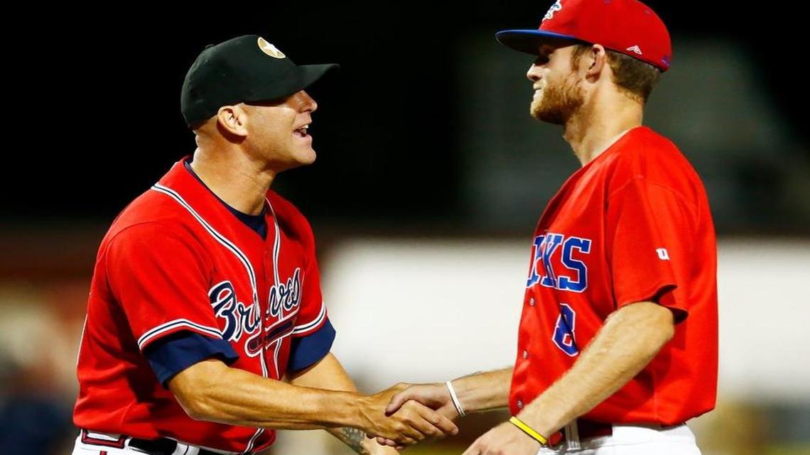 The Stars’ Tim Hudson, left, congratulates the Larks’ Ty Redington following the Larks’ 17-inning victory in the NBC World Series semifinals at Lawrence-Dumont Stadium.