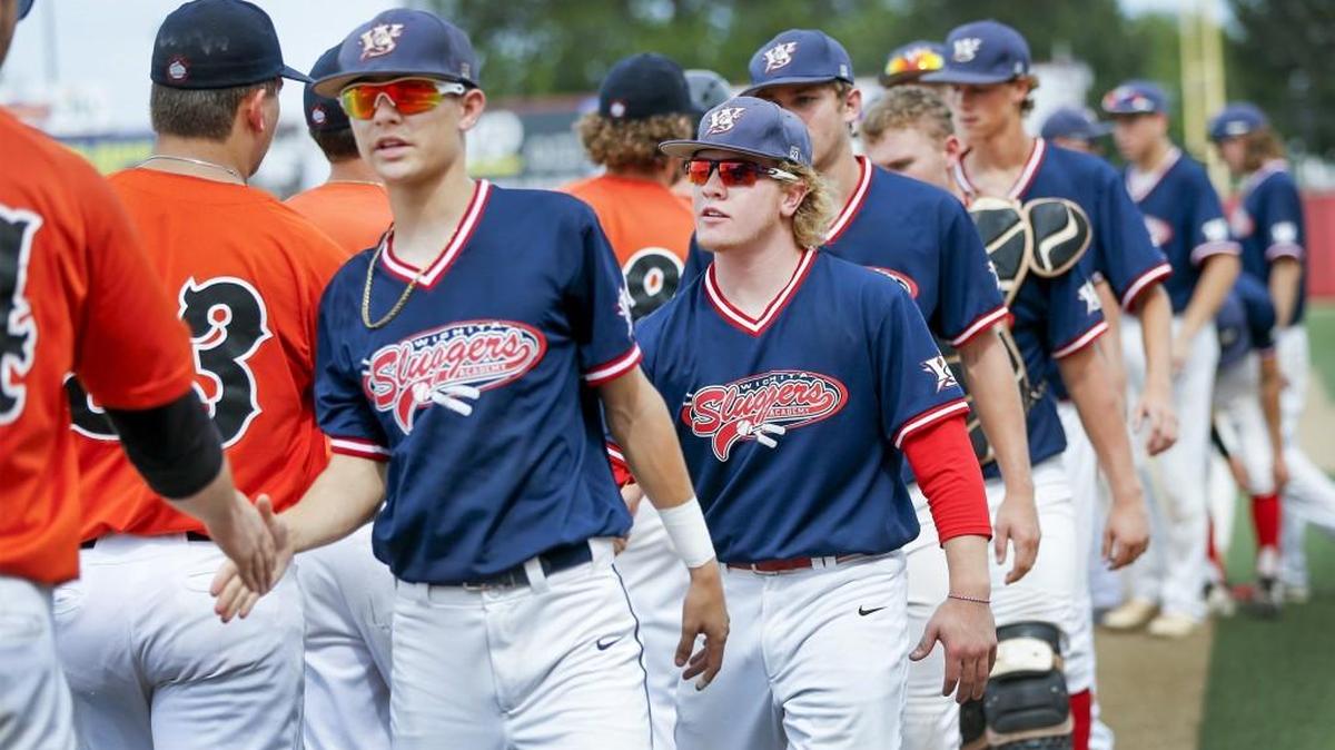 The Wichita Sluggers' Jack Maki, center, and the rest of the team congratulate the Colorado Cyclones after they knocked the Sluggers out of the NBC World Series on Tuesday. The Sluggers, made up of mostly high school players, were the youngest team in the tournament.