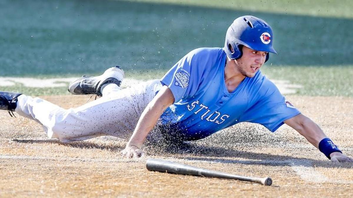 Seattle’s Tanner Arrington slides into home as he ties the score 4-4 against the San Diego Force at the NBC Tournament on Wednesday.Seattle went on to win 5-4.