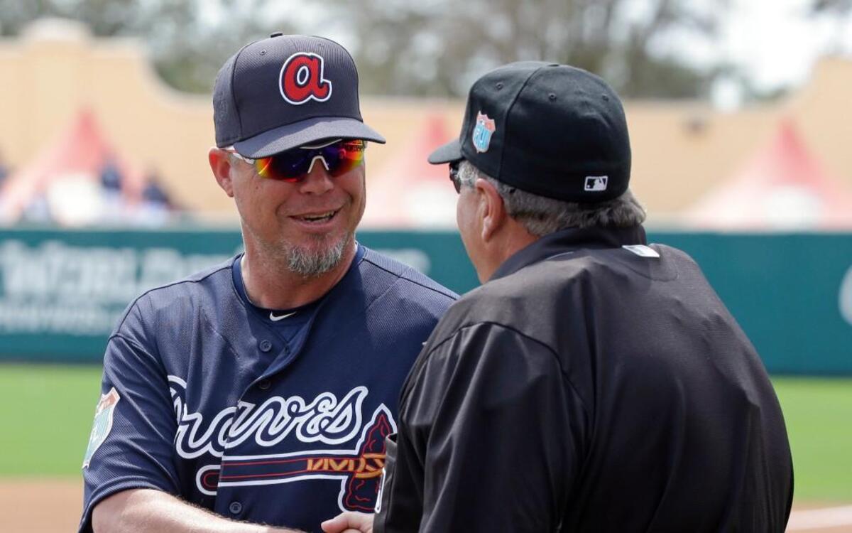 Chipper Jones, left, greets umpire Jerry Layne before a spring training game in March. Jones is a special assistant to the Braves’ general manager after a 19-year career with the club. Jones said Monday he’ll play for the Kansas Stars in the NBC World Series next month.
