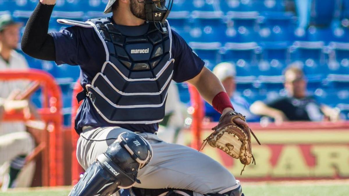 NJCAA catcher Handsome Monica warms up prior to the game Monday evening at Lawrence Dumont Stadium during the NBC World Series.