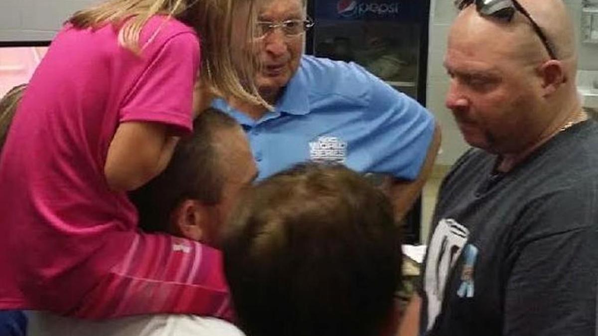 Chad Carlile, father of Kaiser Carlile, lower left, and umpire Mark Goldfeder meet in the umpire’s locker room in the days following Kaiser’s accident. Goldfeder battled depression after returning home, but has since overcome and now travels the country speaking to first responders about his story and helping raise awareness to the stresses of their jobs.