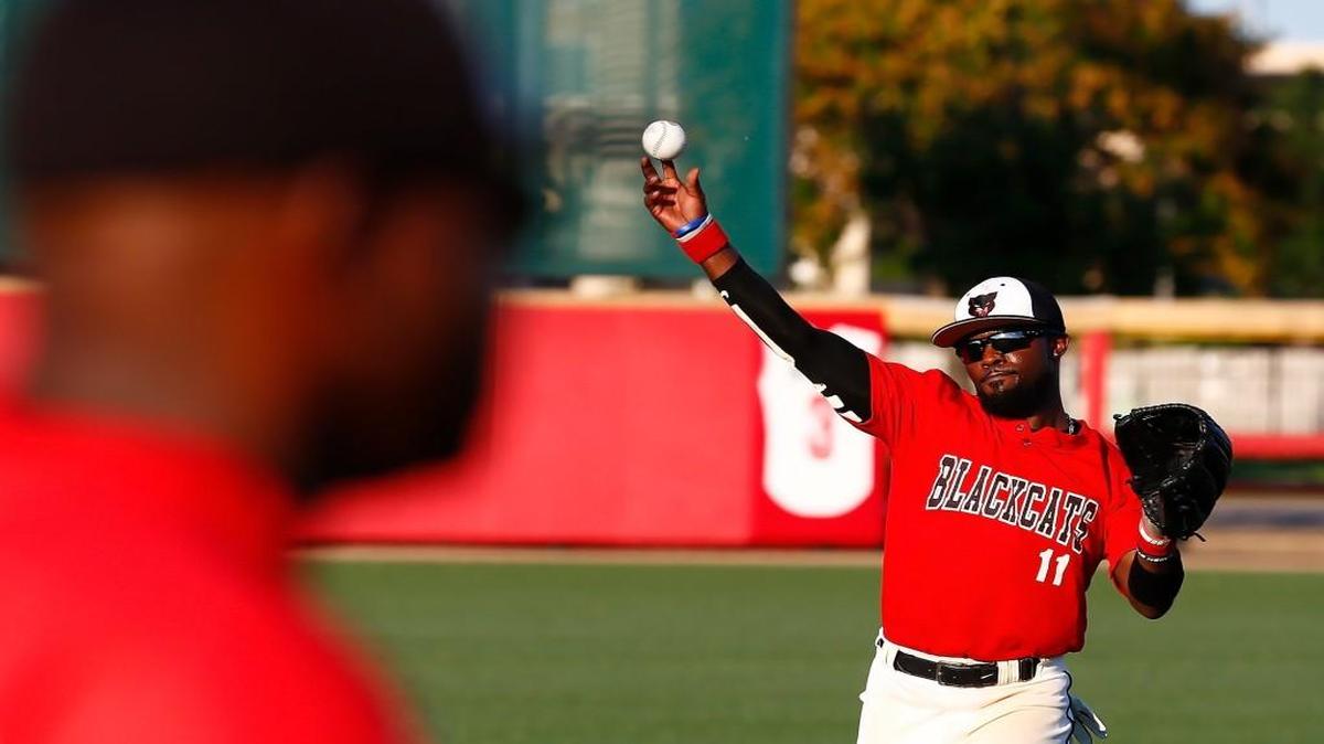 Laurel Black Cats center fielder Steve Tait, right, warms up as manager Jody Bebineaux, left, oversees his team prior to playing in the NBC World Series on Friday night at Lawrence-Dumont Stadium.