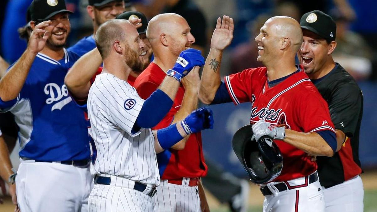 Kansas Stars pitcher Tim Hudson (second from right) gets congratulated by his teammates after hitting a single that won the game against the Seattle Studs 10-2 last Aug. 11.