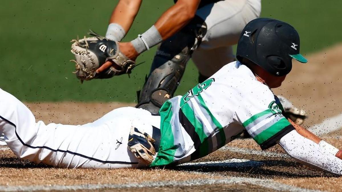 The Action’s Kyle Gray slides safely home in the first inning against the Golden Bears on Saturday in the NBC Tournament at Lawrence-Dumont Stadium.