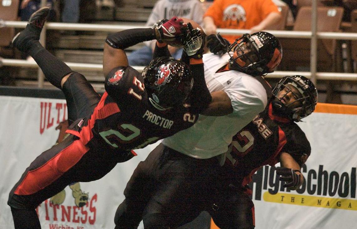 Wichita Wild's Donald Payne catches a touchdown pass as River City Rage's Milton Proctor and Jabari Smith defend during a 2007 game at the Kansas Coliseum. 