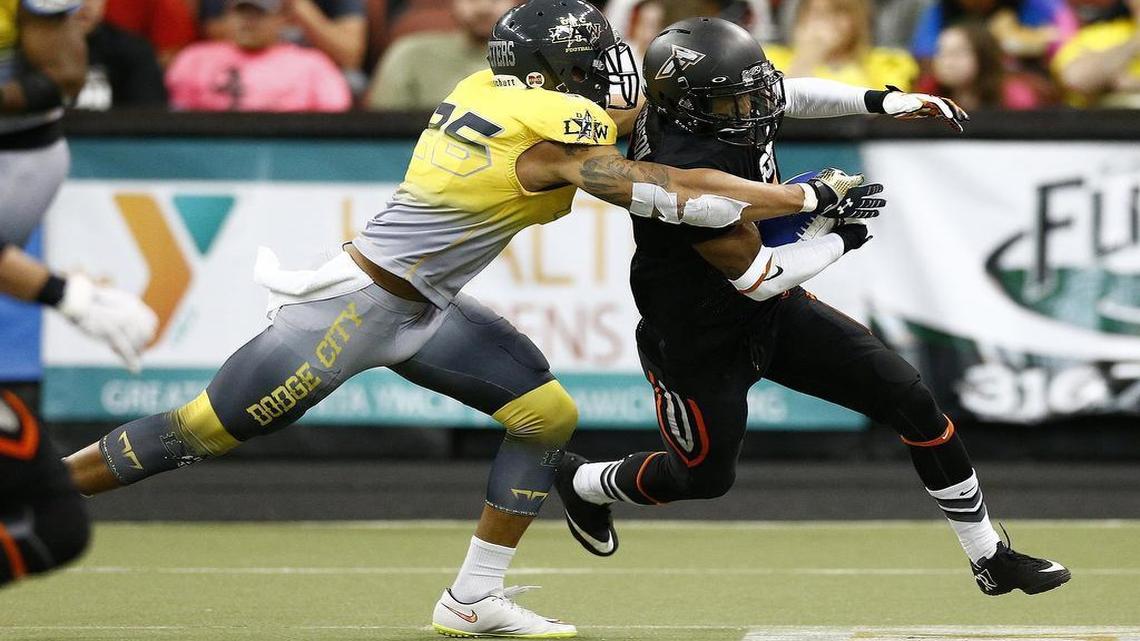 
The Force's Clarence Anderson, right, eludes a tackle by the Law's DeWayne Autrey in the third quarter Friday night at Intrust Bank Arena. 
