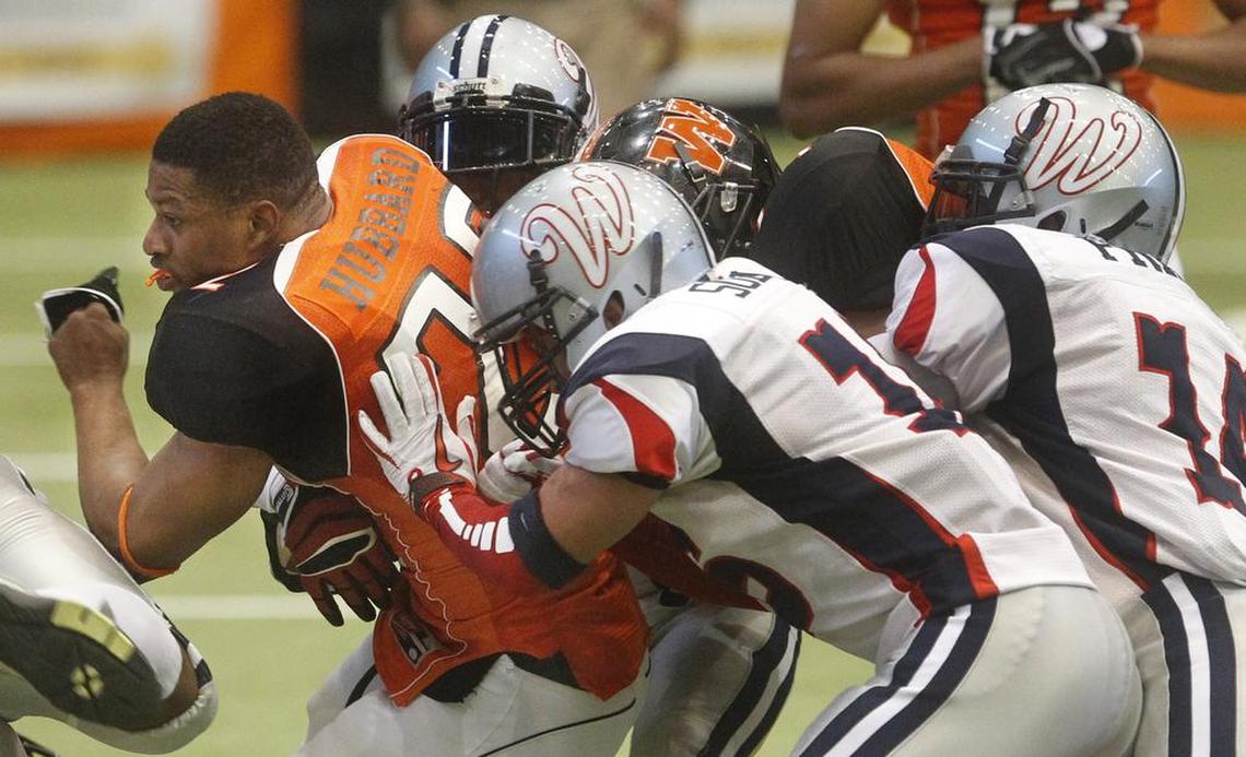 Wichita Wild running back Tywon Hubbard loses his helmet as he’s brought down against the Allen Wranglers on March 24, 2012, at Hartman Arena. 