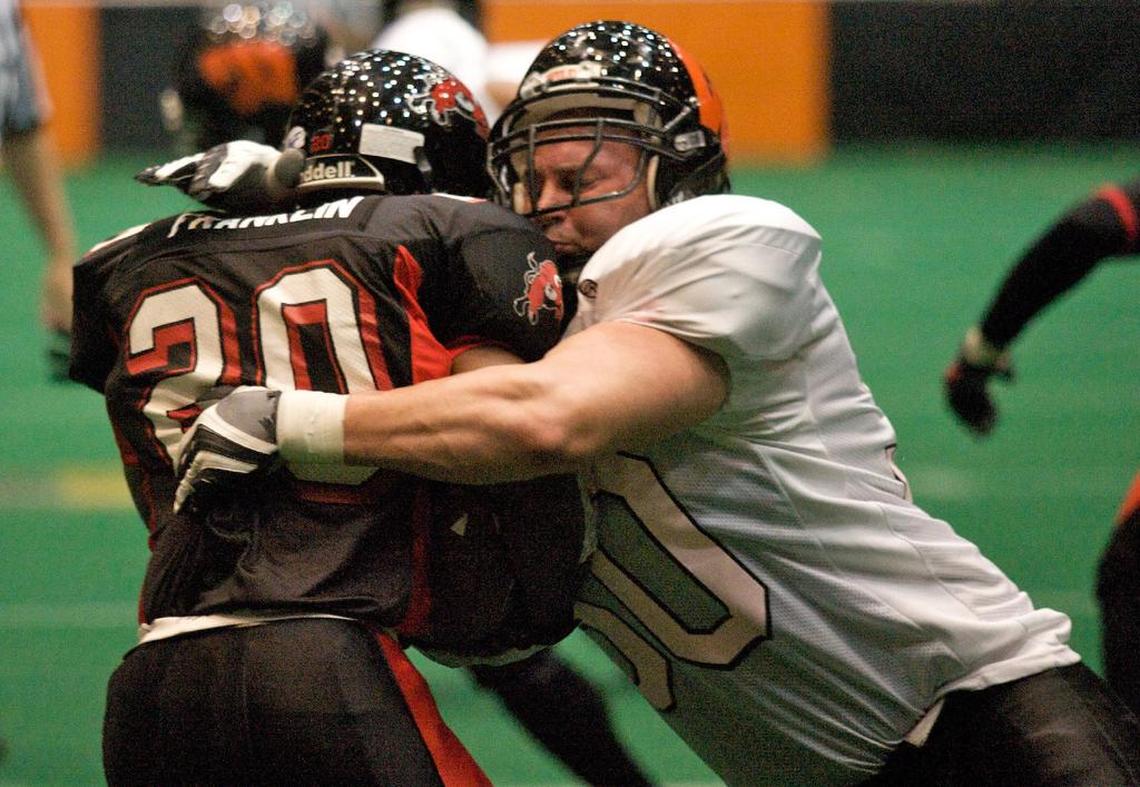 Wichita Wild defensive lineman Justin Montgomery tackles River City Rage's Michael Franklin for a loss of 2 yards in the second quarter of a game at the Kansas Coliseum. 
