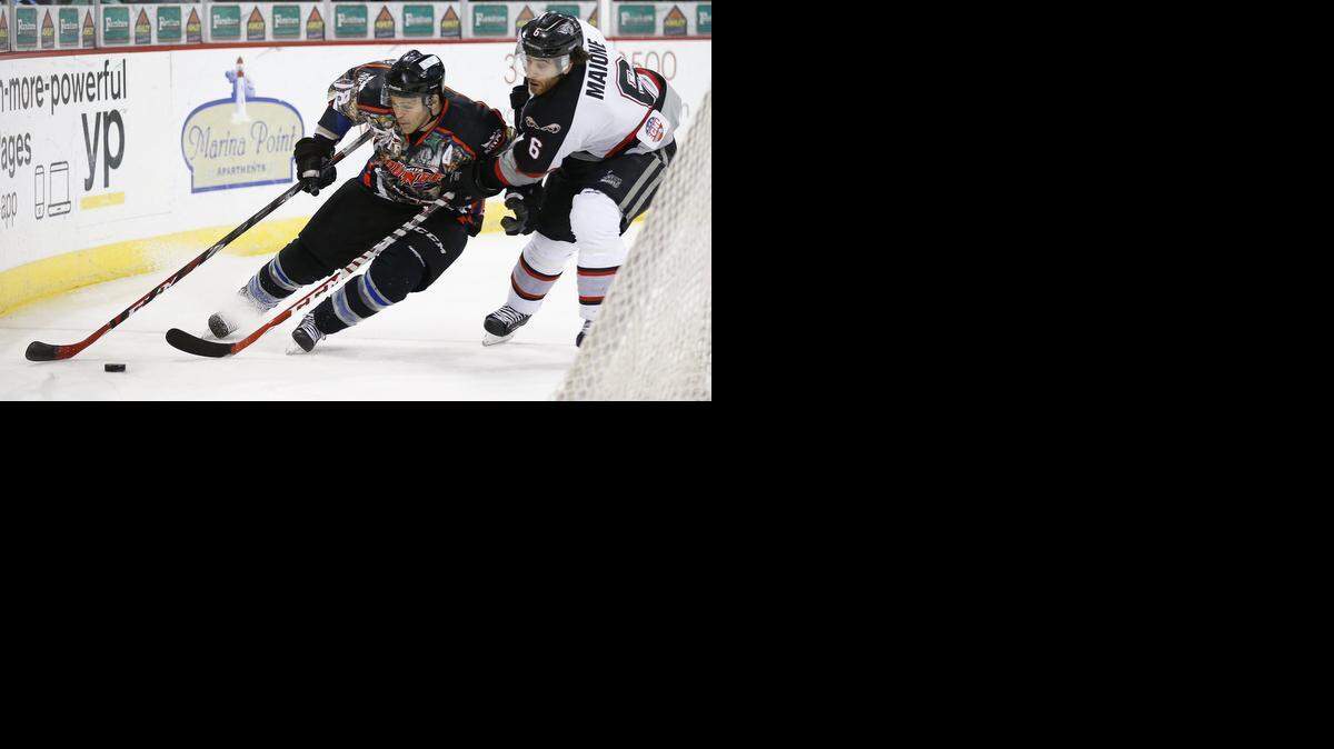 
The Thunder’s Mike Wilson, left, battles for the puck with the Beast’s Matthew Malone on Saturday night at Intrust Bank Arena. 
