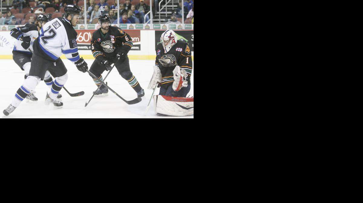 
The Thunder's Erick Lizon (22) scores against Quad City goalie Evan Mosher in the third period Wednesday at Intrust Bank Arena. Lizon, who typically specializes in other parts of the game, broke a scoreless tie.
