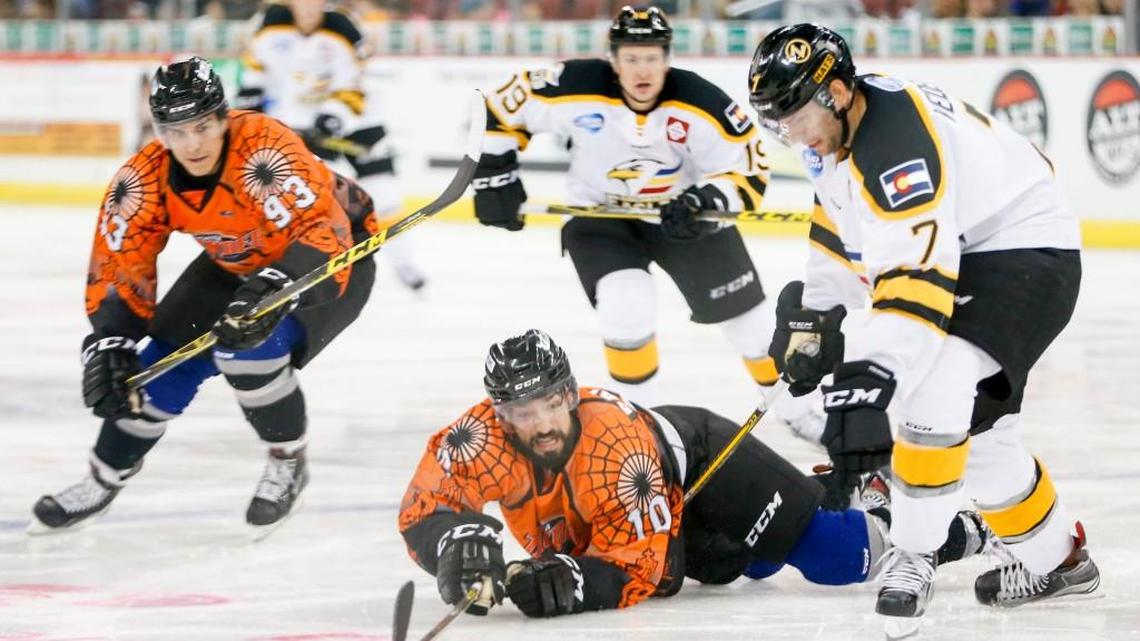 The Thunder's Mason Baptista (10) battles for the puck with Colorado's Adrian Veideman (7) in the third period at Intrust Bank Arena on Saturday.