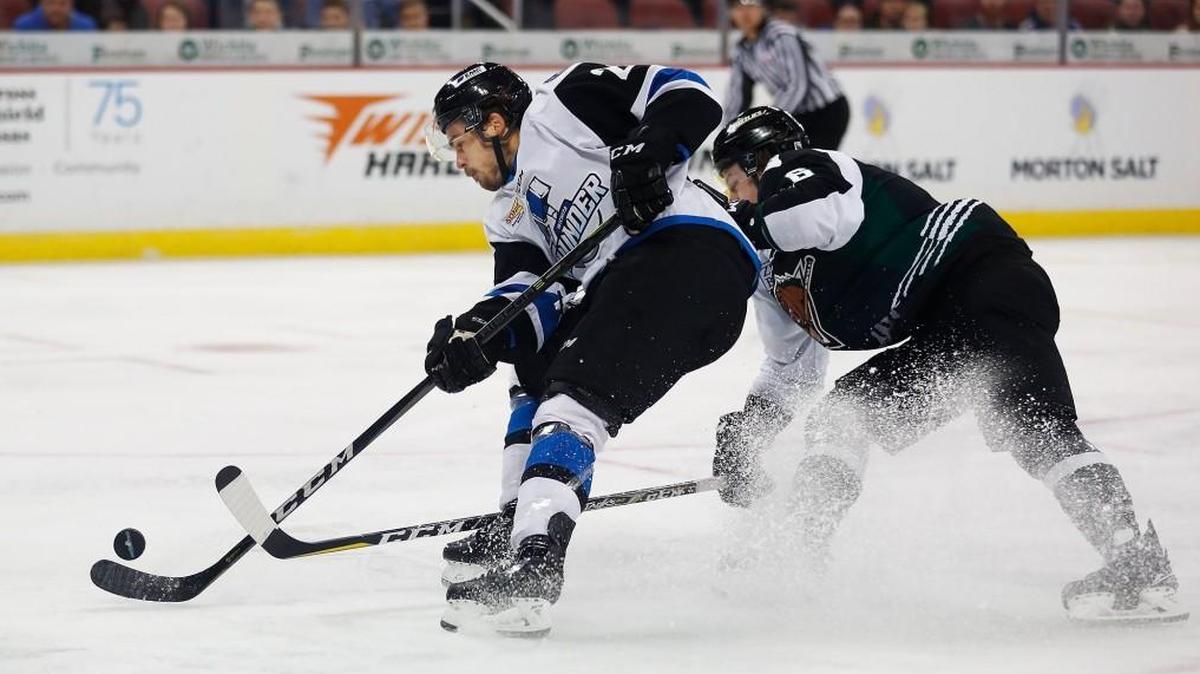 The Thunder's Greg Chase, left, shoots as Utah's Mitch Jones defends in the first period Sunday at Intrust Bank Arena.