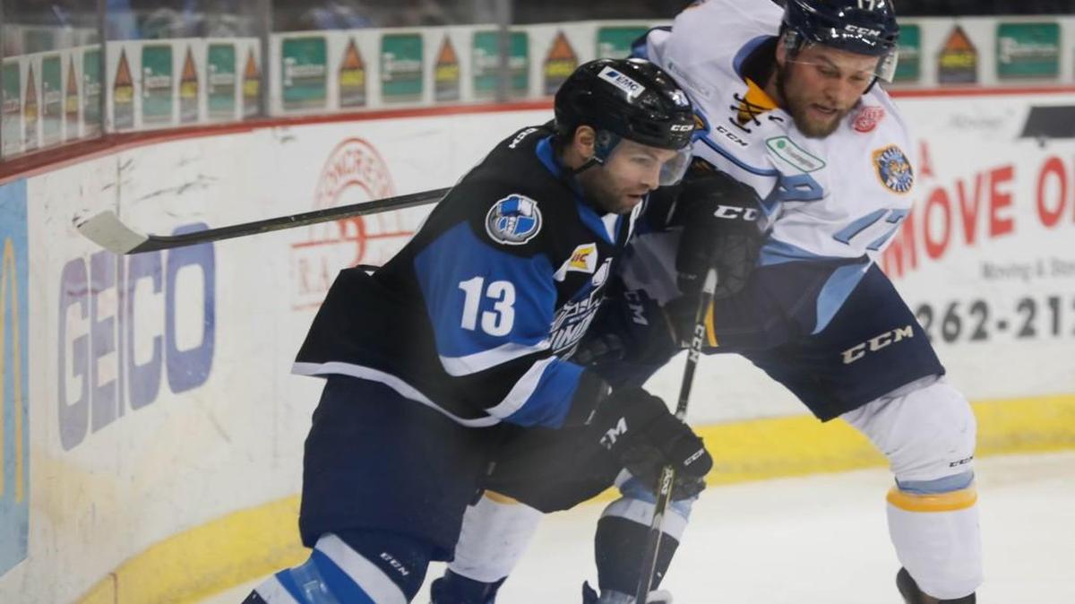 The Thunder’s Ian Lowe, left, fights for the puck during a game against Toledo in February. Lowe may have played his final game with the team on Sunday, the season-finale.