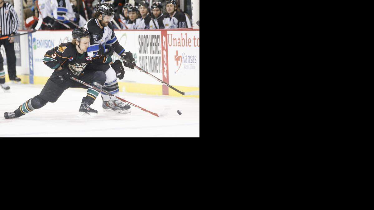 
The Thunder's Todd Hosmer, right, and Quad City's Jannik Christensen battle for the puck in the first period at Intrust Bank Arena on Saturday. 
