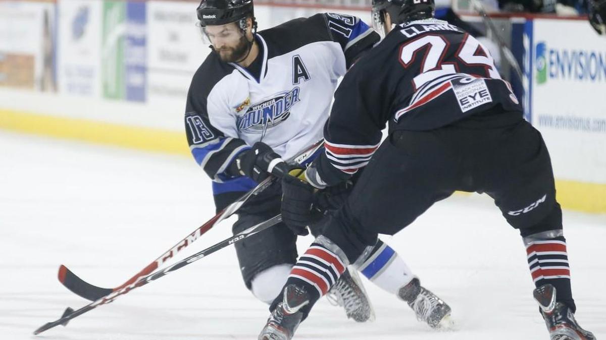 
The Thunder's Ian Lowe, left, brings the puck up the ice against Rapid City's Dylan Clarke (24) last season in Intrust Bank Arena.
