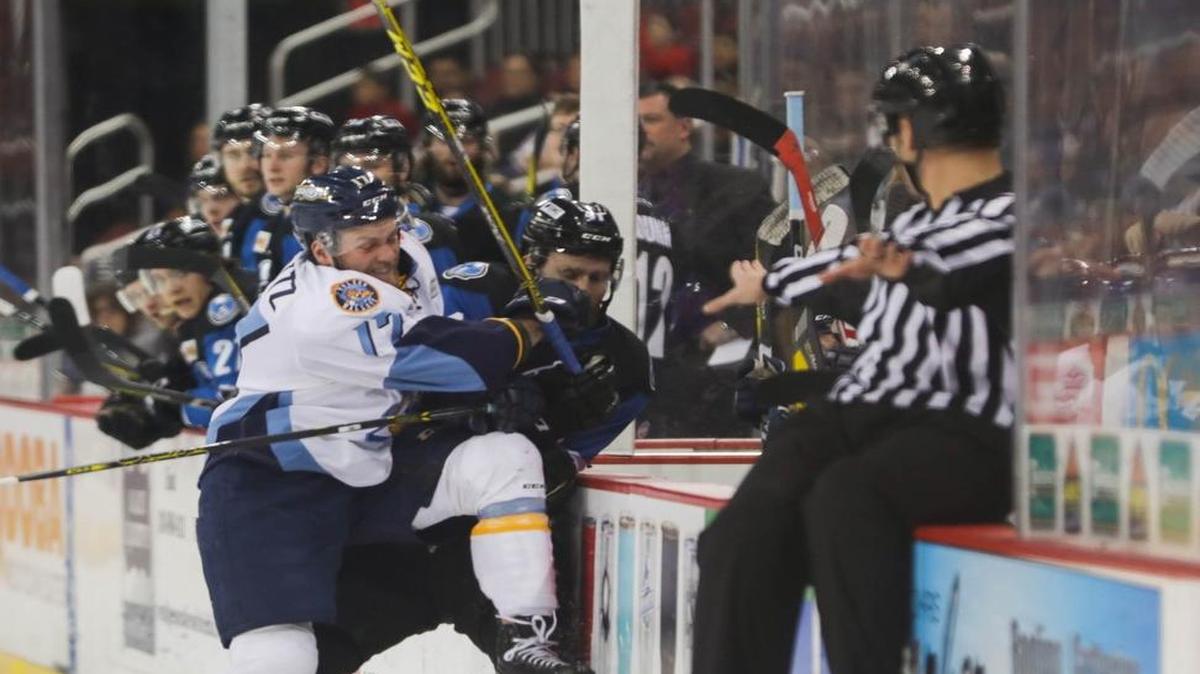 Toledo Walleye forward Beau Schmitz (17) checks Wichita Thunderâ€™s Brandon Carlson (41) near the bench during the first period of play at Intrust Bank Arena, on Friday evening. (Feb. 17, 2017)
