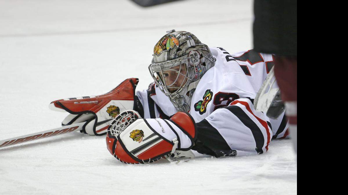
Chicago Blackhawks goalie Scott Darling lays on the ice against the Colorado Avalanche during the first period Wednesday. Darling got the victory.
