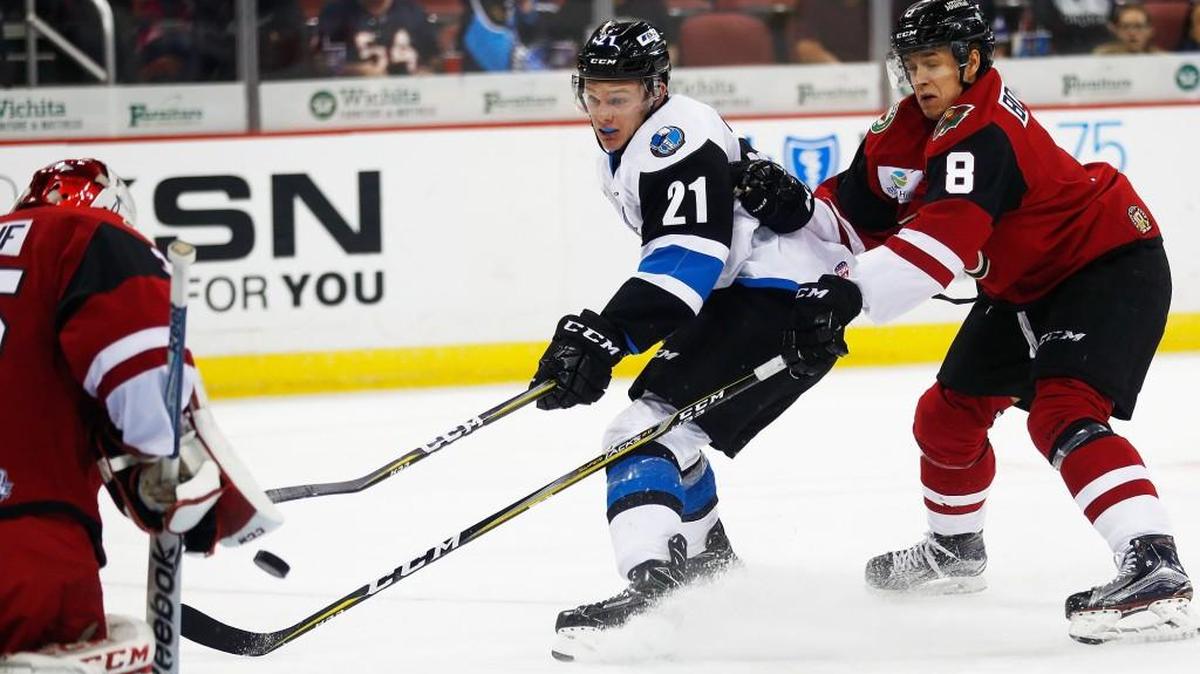 The Thunder's Matt DeBlouw, left, shoots as Rapid City's Gustav Bouramman defends in the first period Sunday at Intrust Bank Arena.