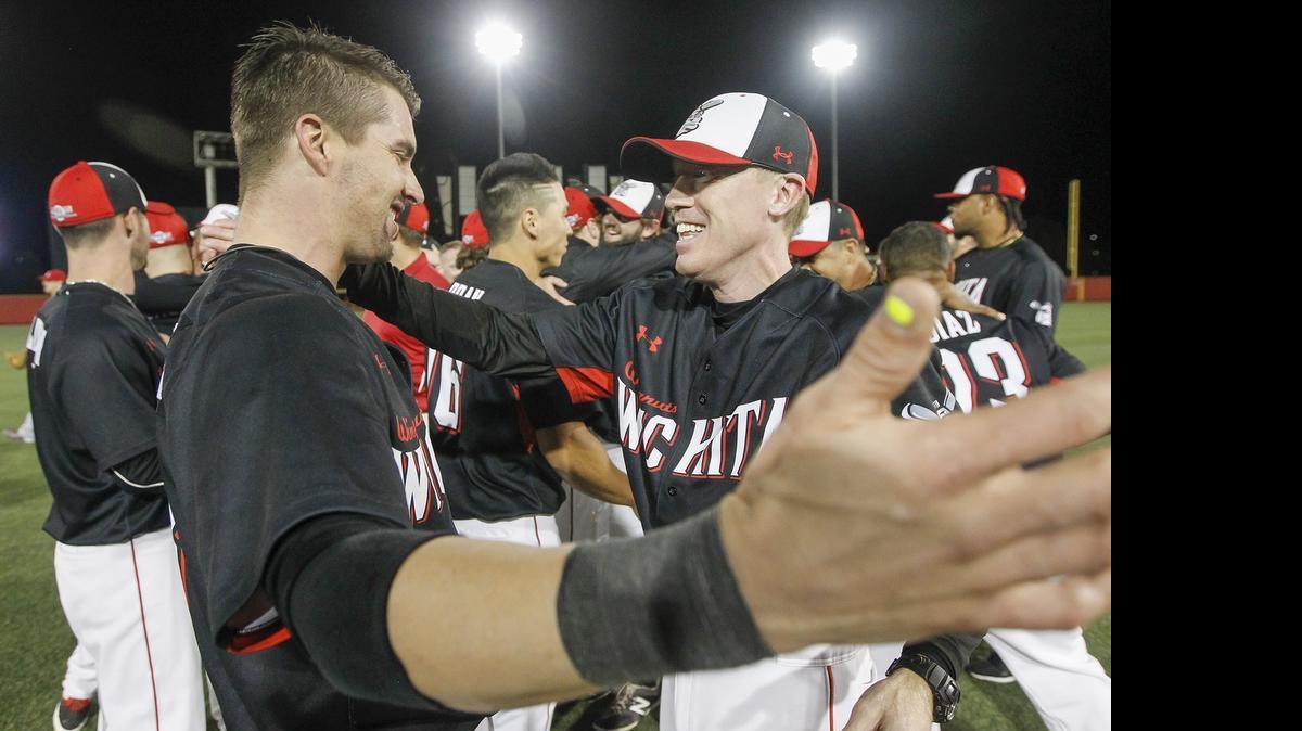 
Wingnuts manager Kevin Hooper hugs catcher Chris McMurray after winning the American Association title at Lawrence-Dumont Stadium on Sept. 13. 

