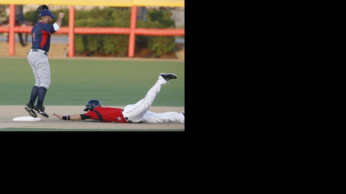 Wingnuts' Taylor Oldham slides safely into second base in the second inning ahead of the tag from Lincoln's Mike Gilmartin.