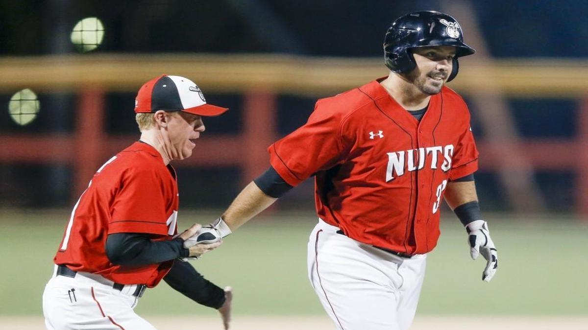 
The Wingnuts’ Andy Laroche, right, is congratulated by manager Kevin Hooper after LaRoche’s game-winning homer in the bottom of the ninth beat St. Paul 6-5 on Tuesday at Lawrence-Dumont Stadium.
