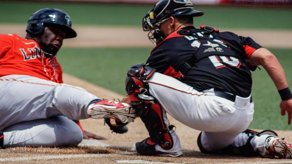 Catcher Brent Dean tags out a Saltdogs runner in the third inning Sunday afternoon at Lawrence–Dumont Stadium.