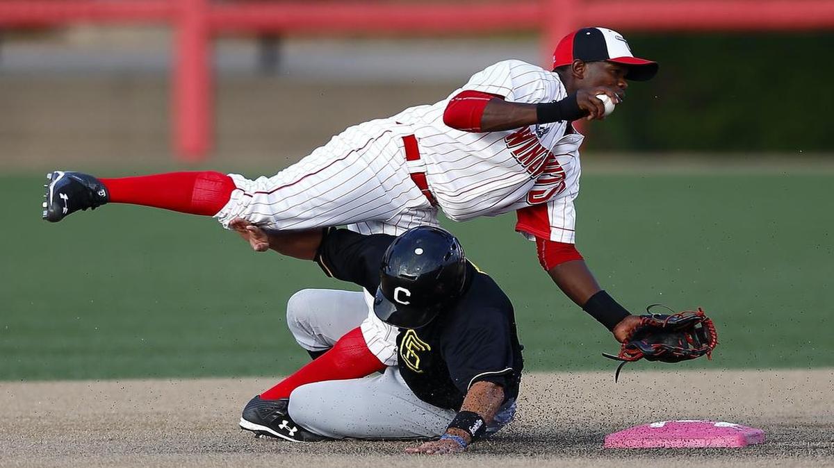 
The Wingnuts' Starlin Rodriguez, top, is upended by a Canaries player in the second inning Sunday at Lawrence-Dumont Stadium. 
