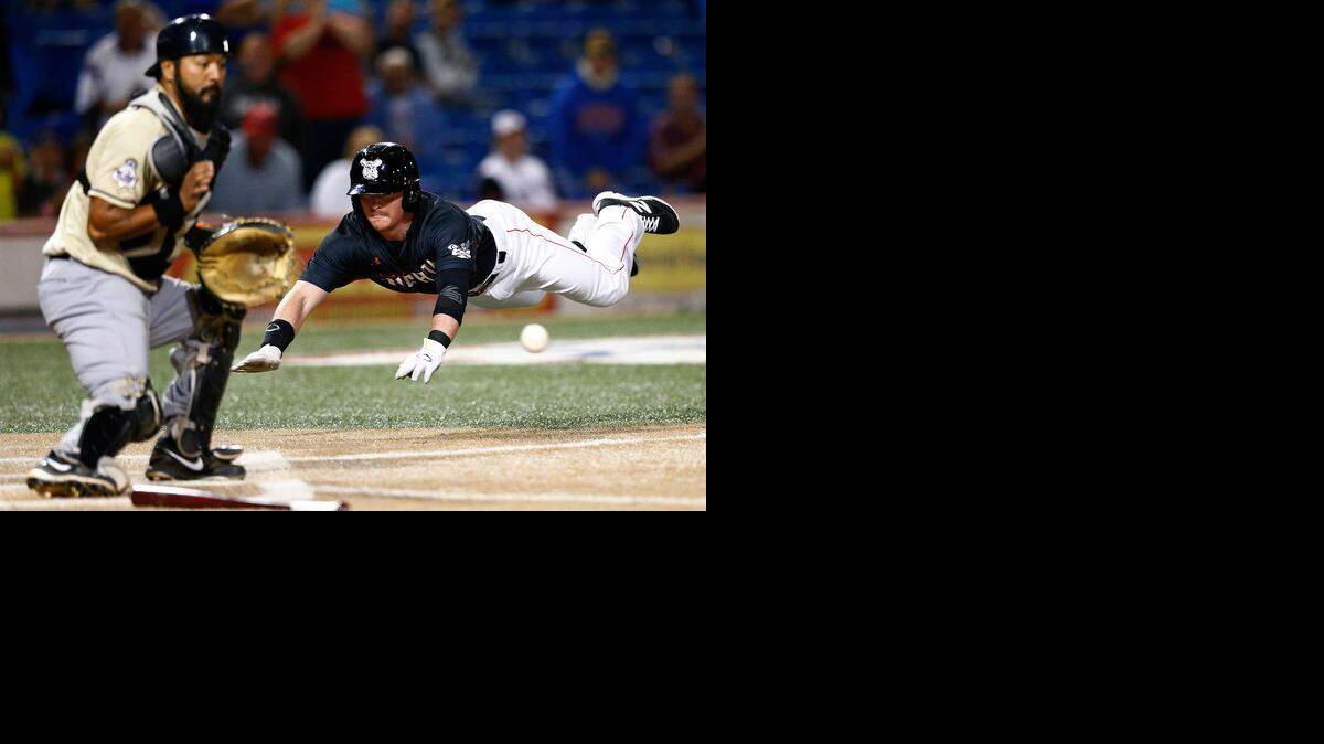 
Wingnuts designated hitter Jake Luce slides home in the fourth inning as Laredo's Carlos Ramirez waits for the ball in Sunday night's game.
