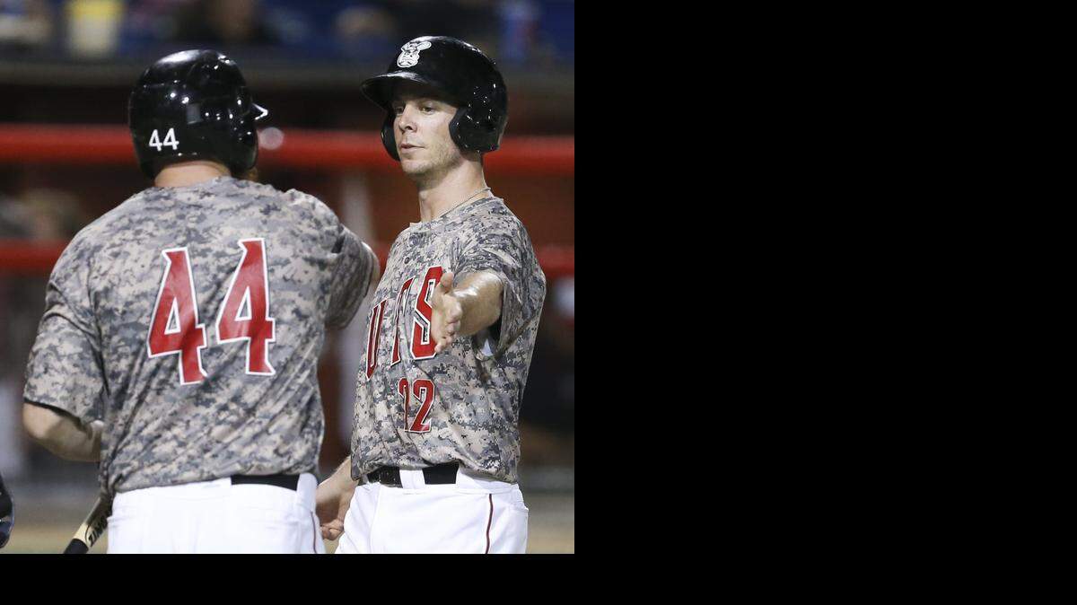 The Wingnuts' Brent Clevlen, right, gets congratulated by teammate Carlo Testa in the fifth inning Friday at Lawrence-Dumont Stadium.