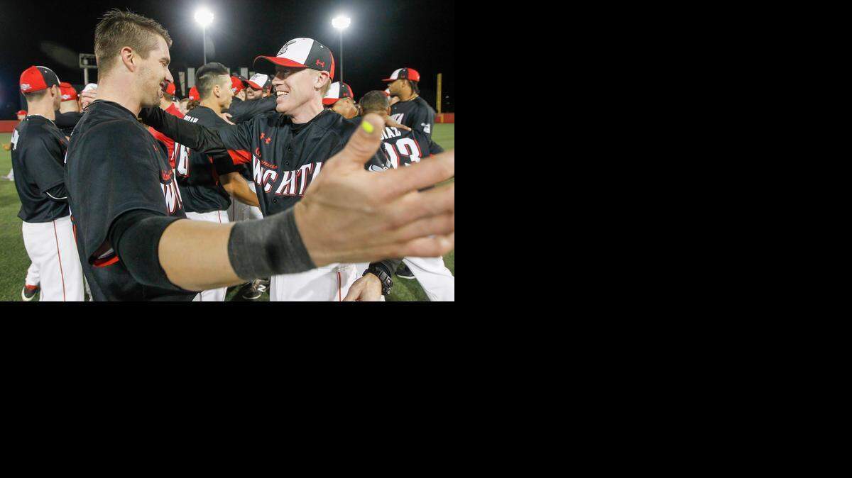 
Wingnuts manager Kevin Hooper hugs catcher Chris McMurray after winning the American Association title at Lawrence-Dumont Stadium on Sept. 13.
