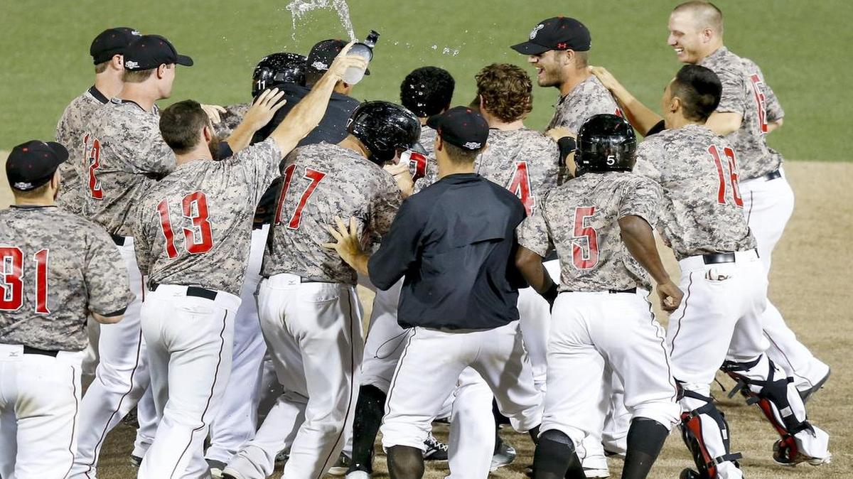 
Luis Hernandez is mobbed by Wingnuts teammates after getting the game-winning hit in the the 10th inning Tuesday at Lawrence-Dumont Stadium. 
