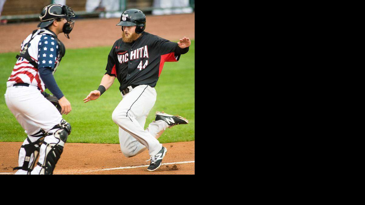 
Carlo Testa slides home after rounding the bases following a botched pickoff play in the first inning Thursday.
