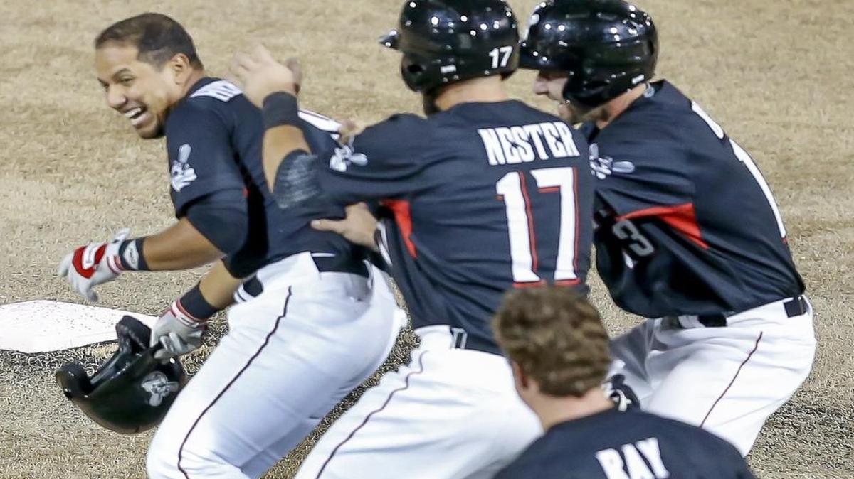 
The Wingnuts' Luis Hernandez, left, gets mobbed by his teammates after his single in the bottom of the 10th inning with the bases loaded won the game against Winnipeg on Tuesday night at LD Stadium. 

