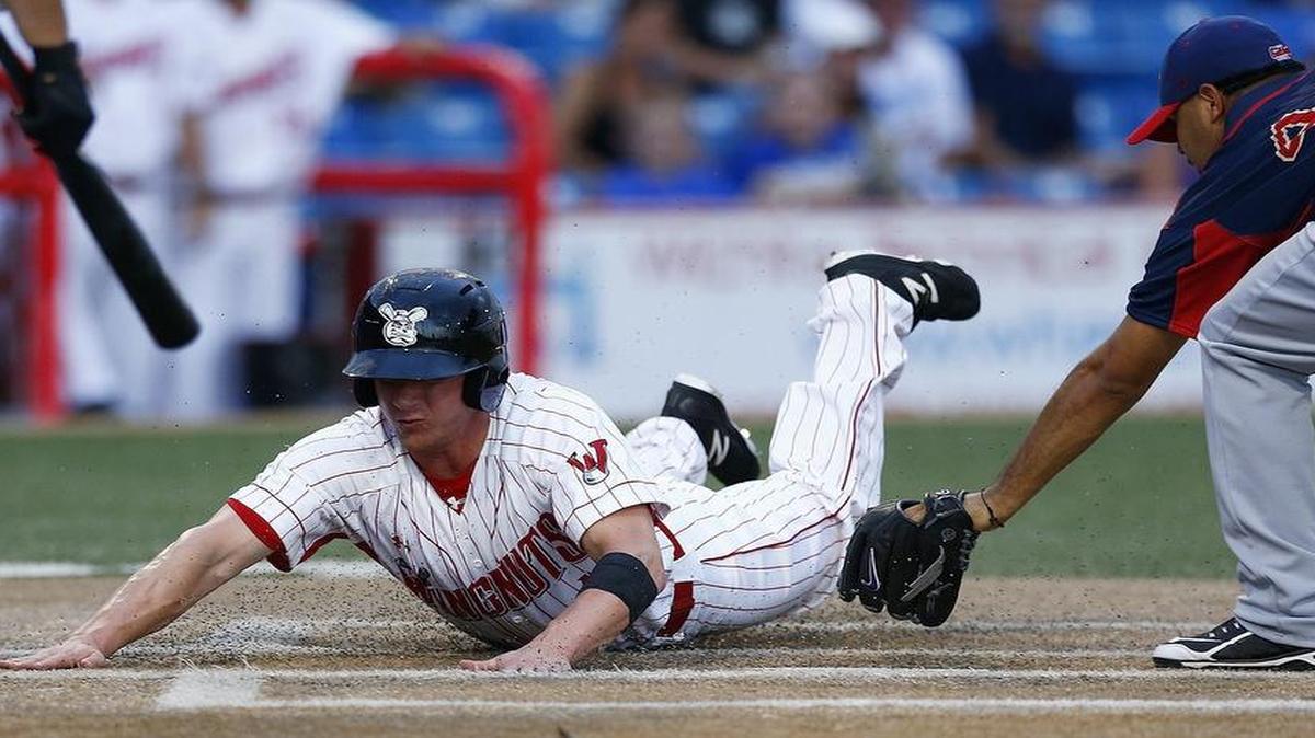 
The Wingnuts' Jayce Ray scores on a wild pitch ahead of the tag by Lincoln's pitcher Luis Chirinos in the second inning Thursday night at Lawrence-Dumont Stadium. 
