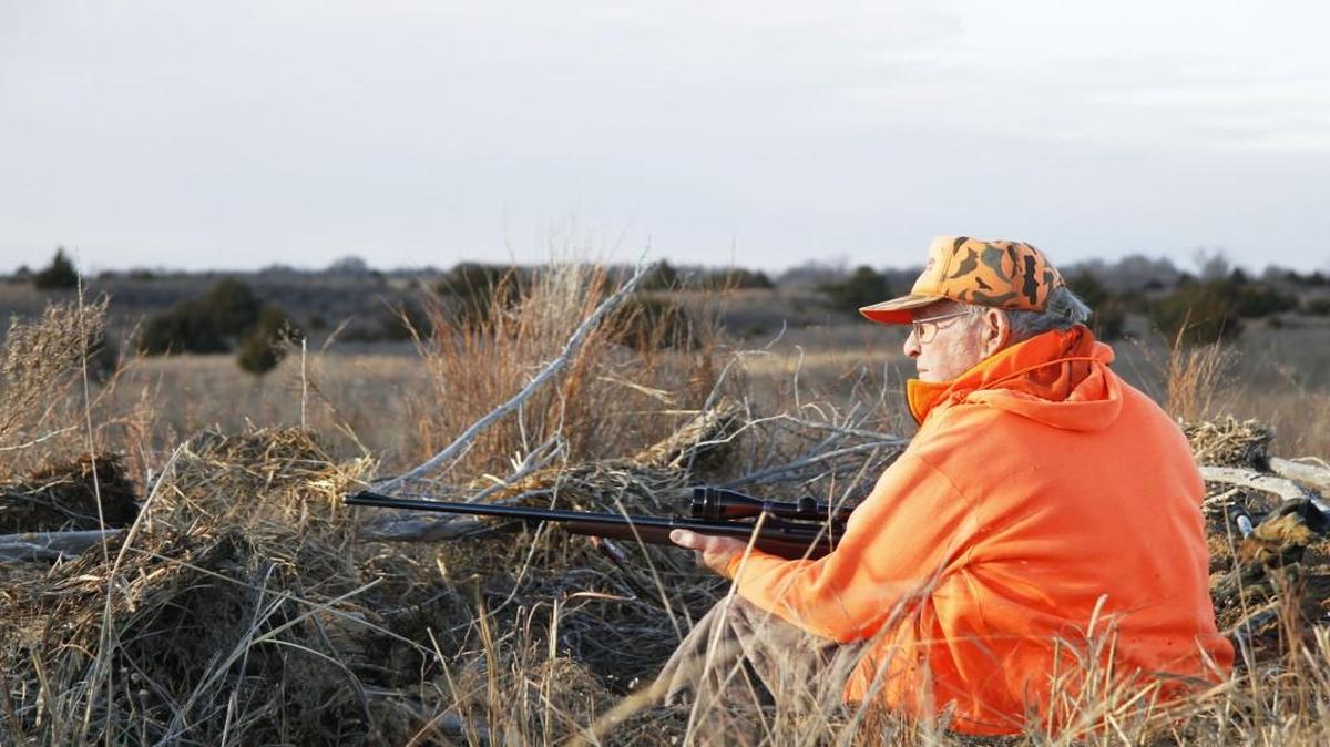 Lee Queal, the biologist who designed Kansas' first deer season in 1965, watches for deer during the firearms deer season, which ends Sunday.