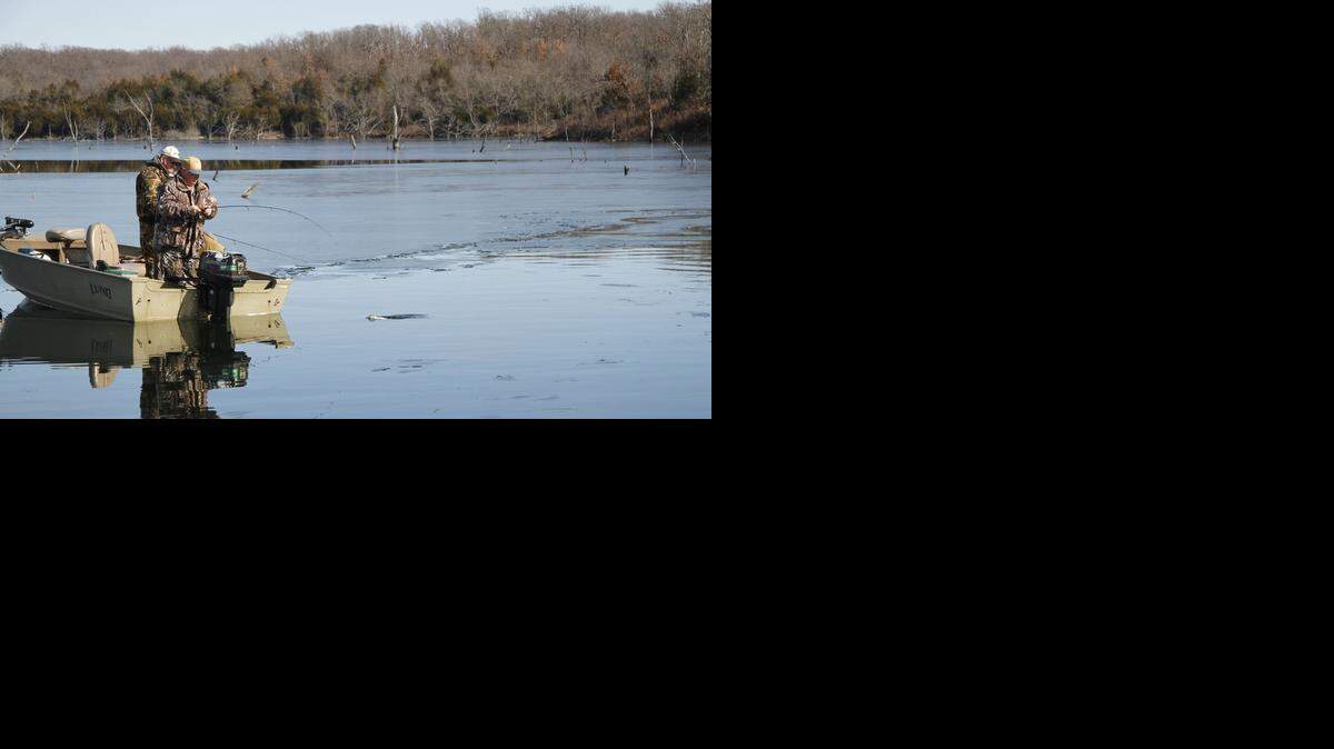 
Oklahoma anglers Bob Mathis, left, and Rollie Williams cast for crappie on a section of water they'd opened at Big Hill Reservoir on Wednesday morning, when most of the lake was coated in ice.
