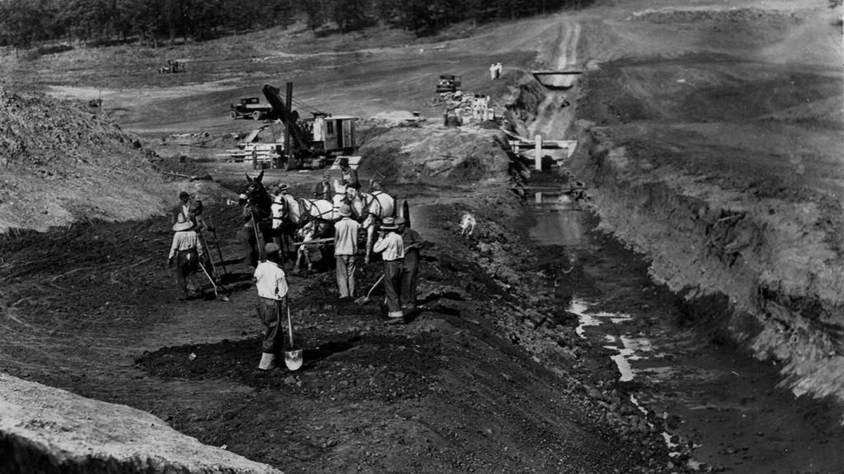 During the Great Depression Civilian Conservation Corps workers, here building Woodson State Fishing Lake, were paid $1 a day, at time when unemployment was high.
