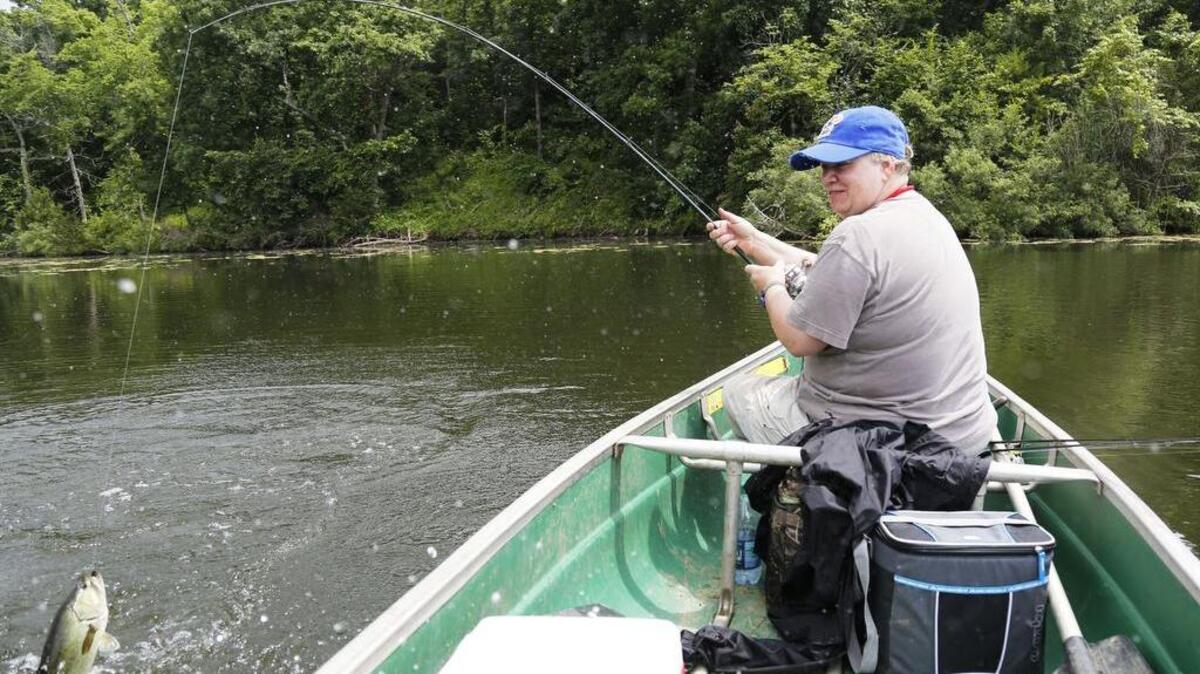 Sherry Chisenhall hangs on while a nice bass jumps Monday morning, her last fishing trip before moving from Kansas. It was one of probably more than 75 bass she caught and released that day, plus a lot of crappie.