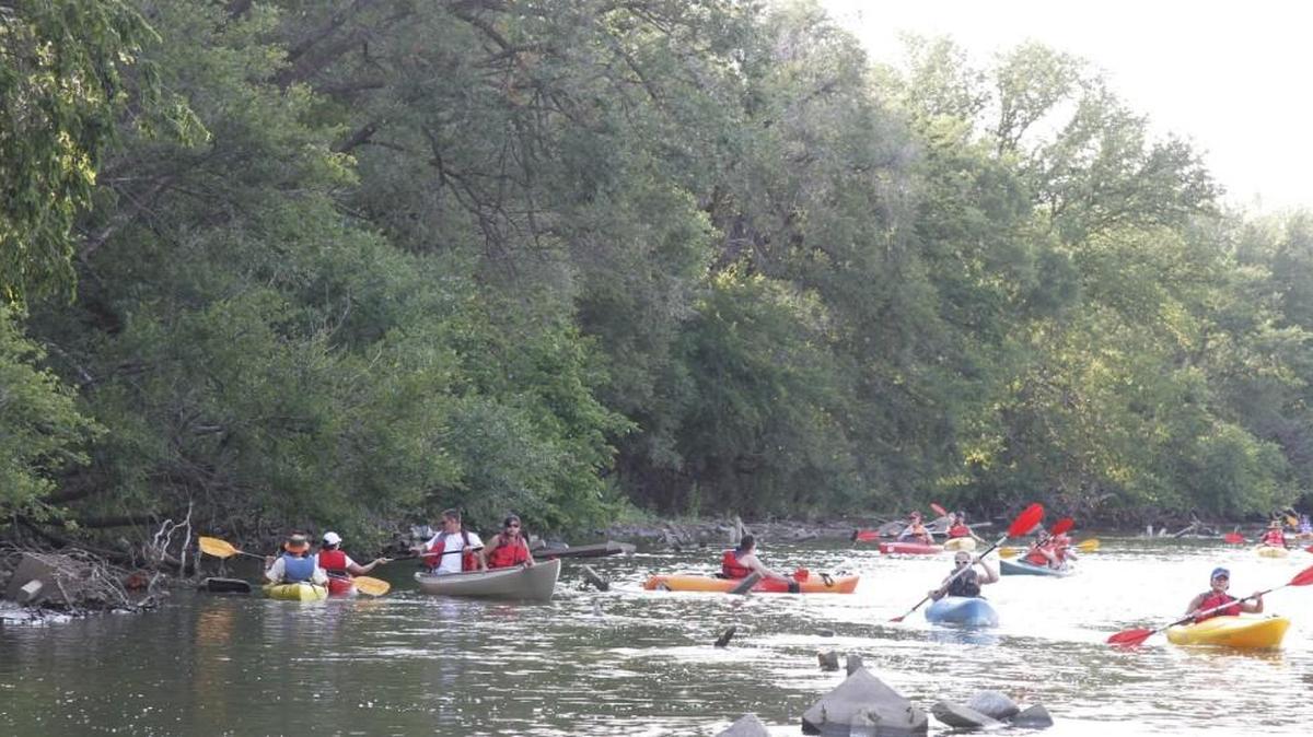 Kayakers travel the Arkansas River on a twilight float hosted by the Arkansas River Coalition. (2012)