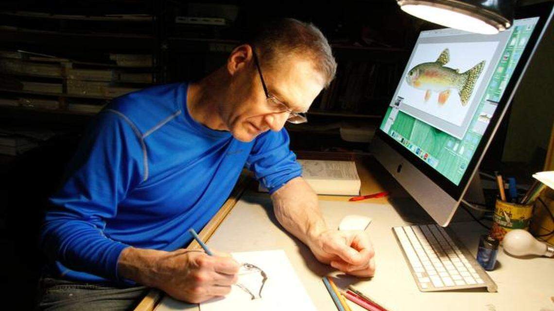 
Working at his home in Leawood, Joseph Tomelleri works on the image of a hatchet fish, a creature of the deep Atlantic ocean. On his screen is the image of a Mexican trout he created.
