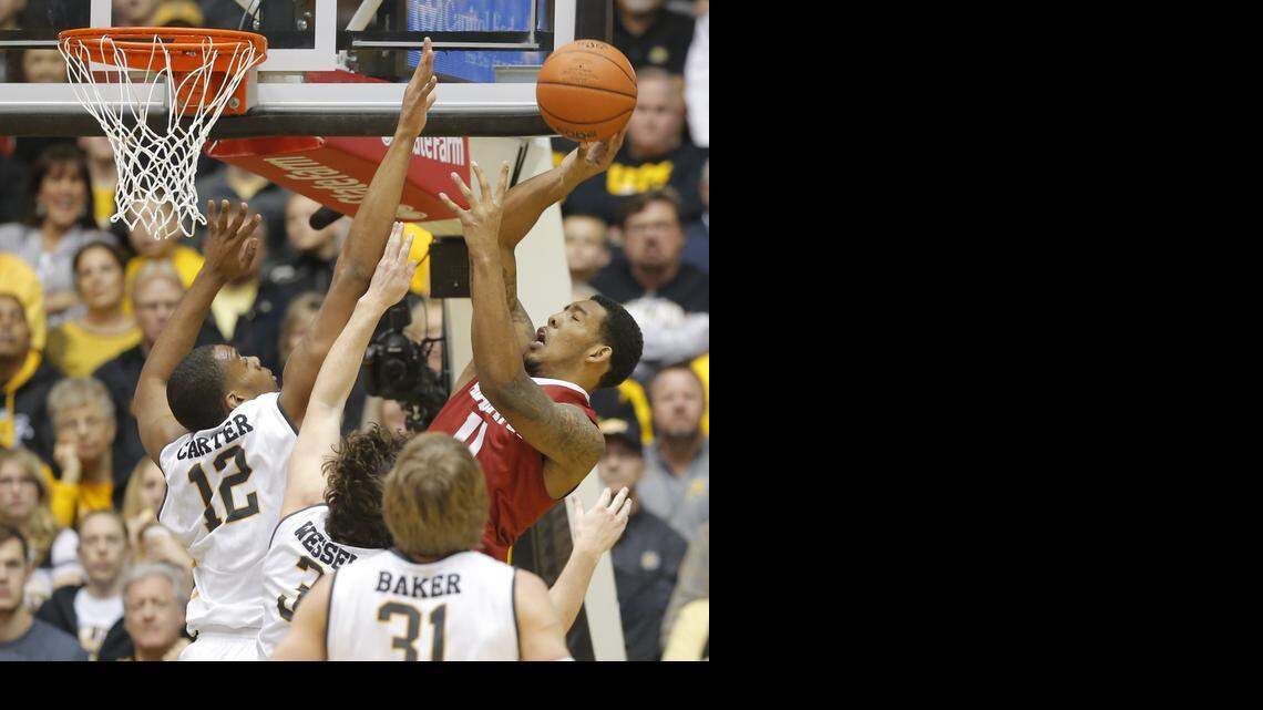 
Wichita State's Darius Carter, left, Evan Wessel (3) and Ron Baker (41) try to block the shot of Alabama's Shannon Hale during the first half of their game at Koch Arena on Tuesday night. 
