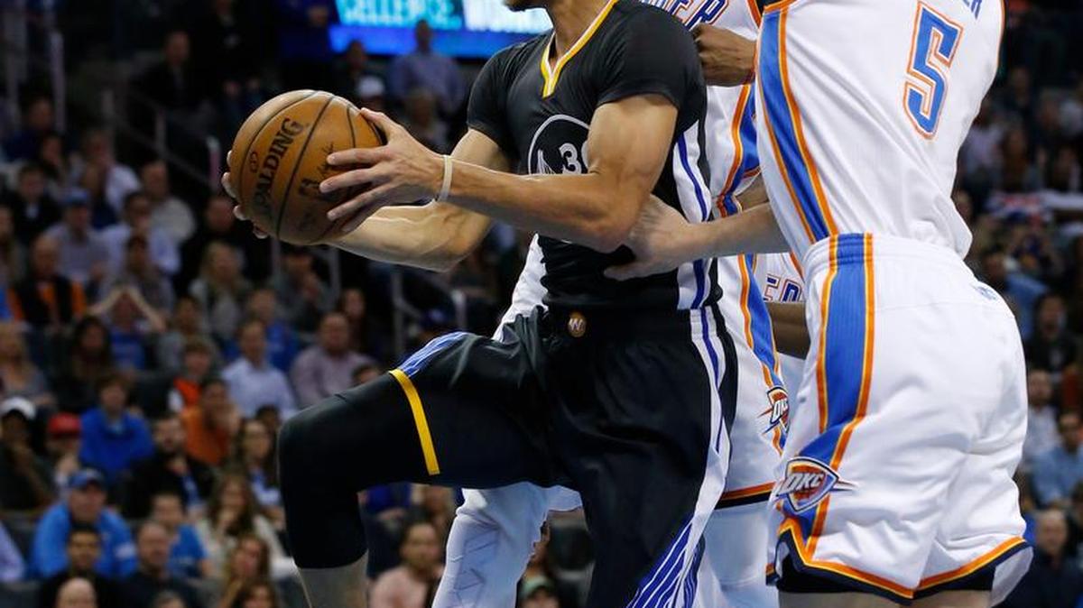Golden State Warriors guard Stephen Curry takes the ball to the basket against the Oklahoma City Thunder on Feb. 27 in Oklahoma City.