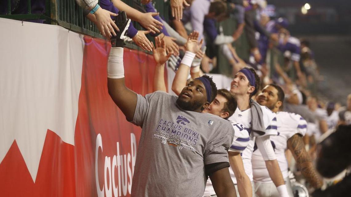 K-State players "high five" fans after the Cactus Bowl Tuesday. (December 26, 2017)