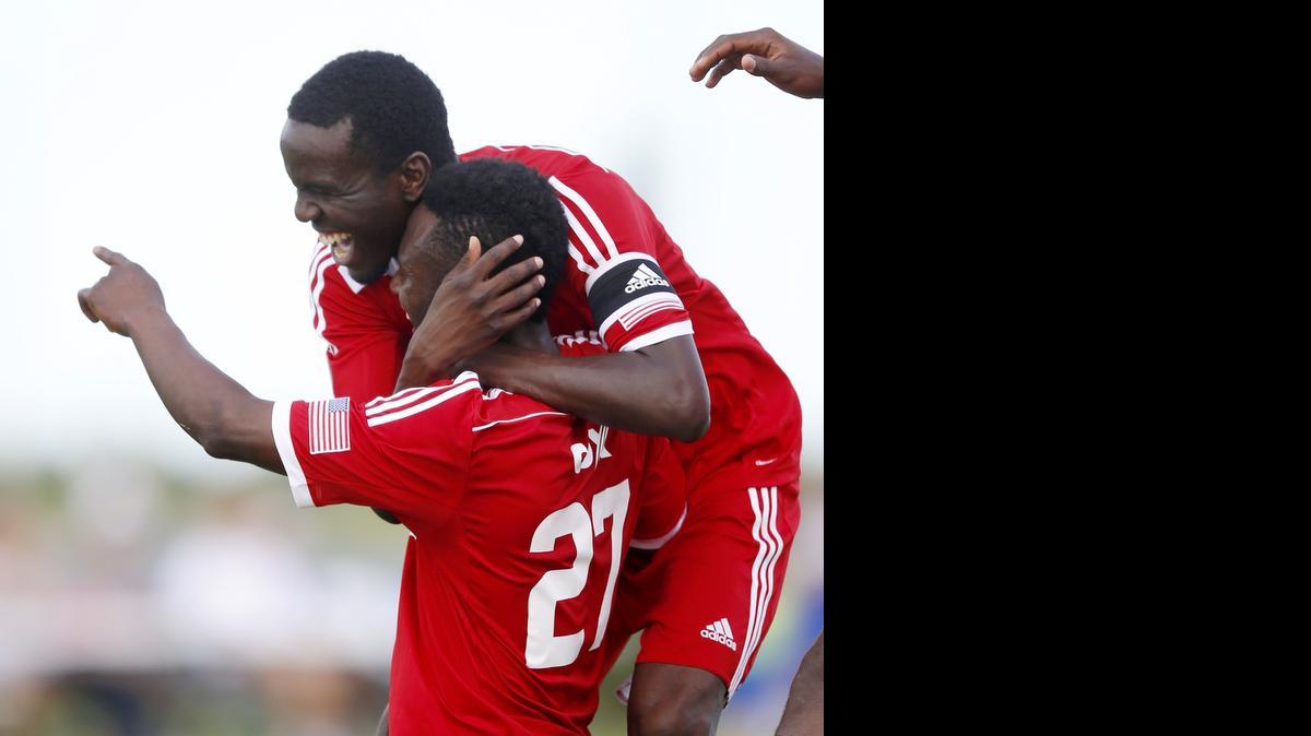 
FC Wichita player Chisom Ogbonna is hugged by teammate Shadow Sebele after scoring against Liverpool International Academy on Sunday in Wichita. 
