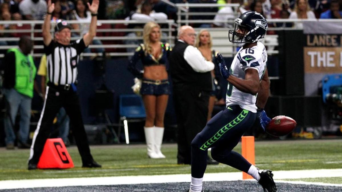 
Seattle’s Tyler Lockett celebrates after scoring on a 57-yard punt return during the first quarter Sunday in St. Louis.
