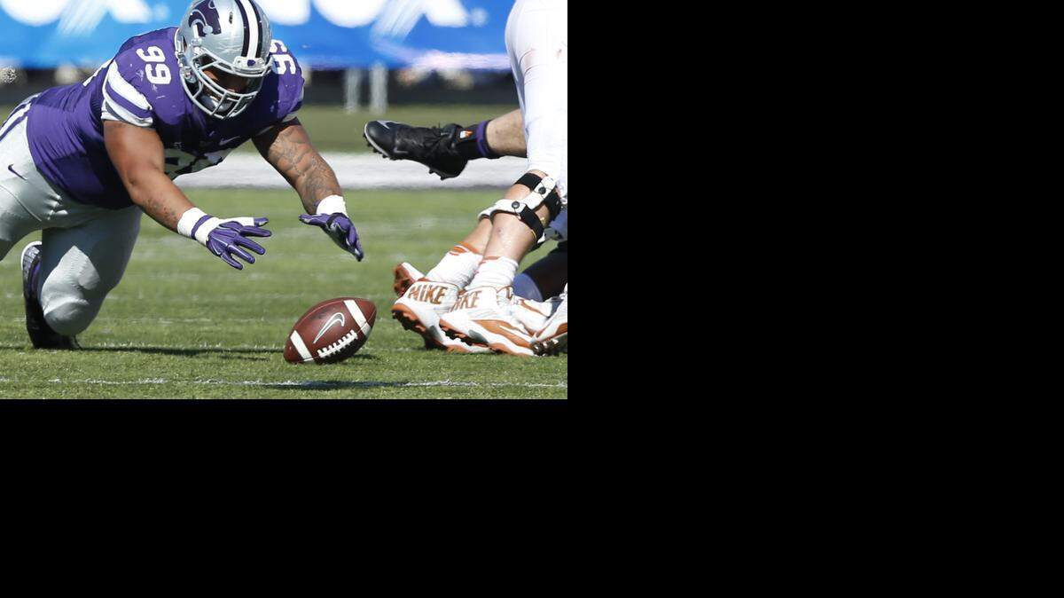 
K-State defensive tackle Valentino Coleman (99) dives on a Texas fumble Saturday in the 3rd quarter. (October 25, 2014) 
