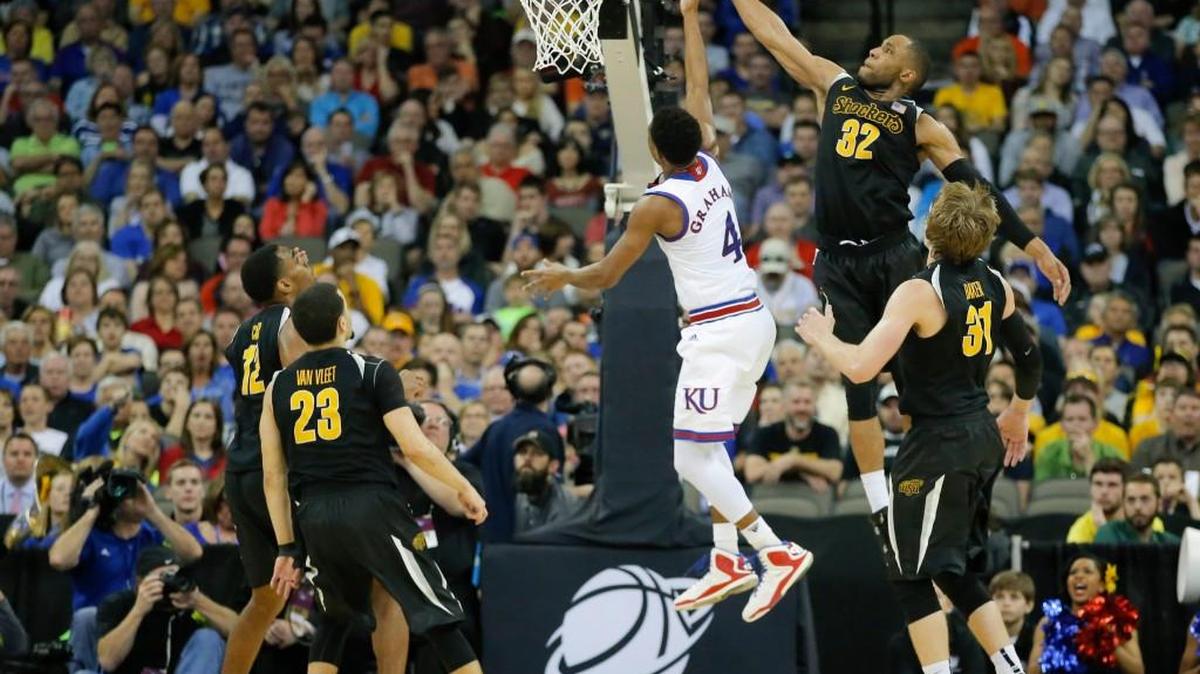 Wichita State guard Tekele Cotton blocks a shot from Kansas guard Devonte Graham. (March 22, 2015)