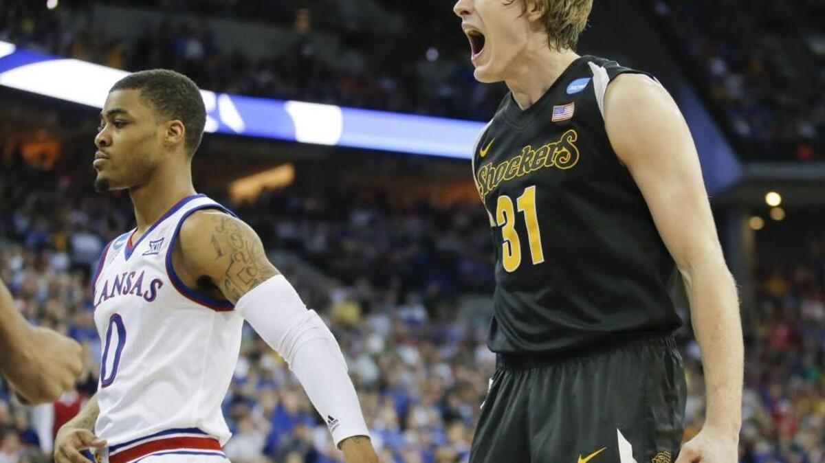 Wichita State guard Ron Baker screams out in celebration after teammate Darius Carter hit a shot and was fouled during the second half against Kansas in the NCAA Tournament.